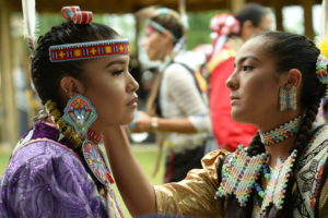 Two native women preparing for a Native American cultural event. Photo by Larry Gouine.